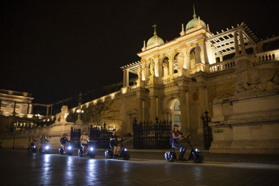 Budapest: Buda Castle E-Scooter Evening Tour - Matthias Church after dark: the lights do the work